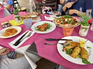 Only tomatoes in the middle of the table and dish on the right are vegans!  at Ristoro Dantesca in Pisa