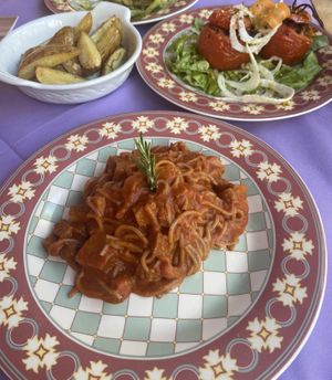 Vegan Spaghetti with Seitan Ragu, pistachio stuffed tomatoes and baked rosemary potatoess  at Ristoro Dantesca in Pisa