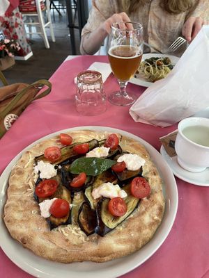 Great vegan pizza with eggplant and vegan ‘stracciatella’ which is a vegan cheese. And the non-clam spaghetti with shelled pistachios and seaweed   at Ristoro Dantesca in Pisa