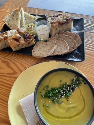 Bread basket with spreads and soup of the day  at Orteá - Vegan Collective in Lisbon