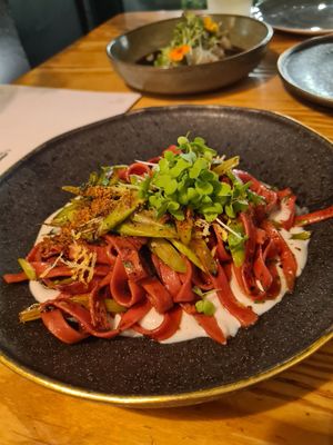 Beetroot pasta in cheese sauce with asparagus and thyme at Orteá - Vegan Collective in Lisbon