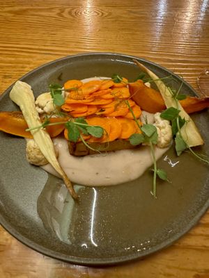 creamy white bean puree, sautéed spinach, roasted Hokkaido parsnip, cauliflower, pumpkin in miso butter and tofu loin and carrot scales. ❤️🌱🇵🇹  at Orteá - Vegan Collective in Lisbon