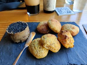 Vegan cheese covered with pepper, gluten-free breads baked at the very moment at Orteá - Vegan Collective in Lisbon