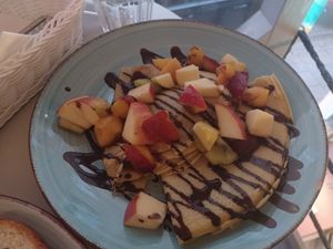Crepes with cocoa filling, chocolate sauce, and fresh fruit at Cakester Cafe in Krakow
