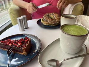 Avo and hummus bagel, matcha with soy milk and cherry and choc cake🙌  at Cakester Cafe in Krakow