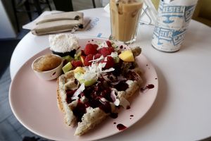 Vegan chia waffles with coconut cream and fruit at Cakester Cafe in Krakow