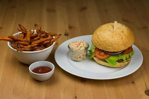 Burger with coleslaw salad and sweet potato fries at VegGo Bistro in Zilina