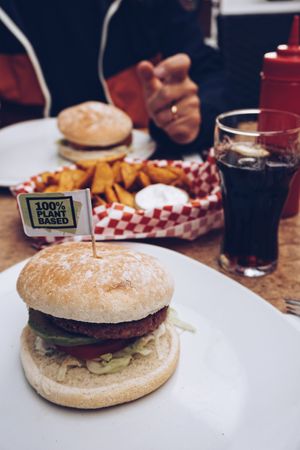 The burger has been served on a plain white plate. at Oilers69 in Haiming