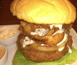 Mighty vegan burger served with onion rings on a grilled spelt bun  at The Electric Vegan in Dublin