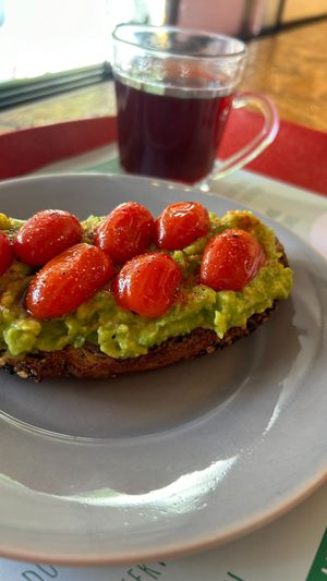 tomato toast with avocado pasta, confit grape tomato and paprica at Veg To Go in Sao Paulo