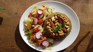 Freekeh, real Syrian fish with puffend green what,  four kinds of nuts, vegan herby-sausages and a Syrian salad. at Syrisch Eethuis Moushmoush in Arnhem
