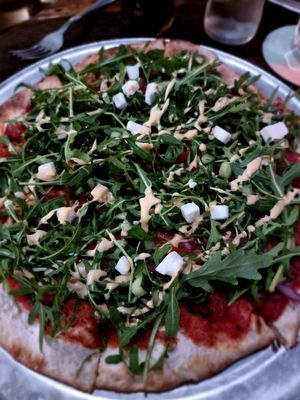 The new vegan pizza with ruccoka and vegan feta at Otomat in Bruges