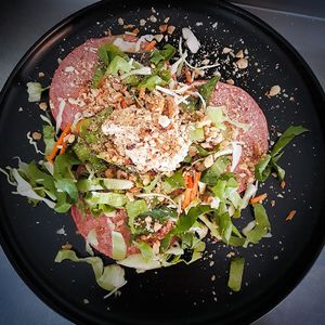 Beetroot oatpancakes with mixed salad, hummus and mixed nuts at Oloa in Enschede