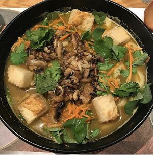 Vegan Kare Burosu - shichimi coated silken tofu, grilled mixed mushrooms, udon noodles, curried vegetable broth and pea shoots. at Wagamama in Watford