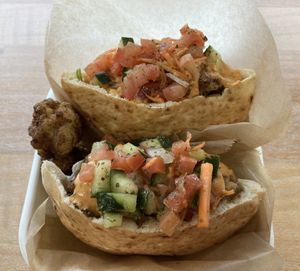 Cauliflower shawarma.  Crispy cauliflower tossed in shawarma spices served in pita bread layered in mixed greens, salata Baladi, and spicy tahini sauce  at POTs - Cloud Kitchen in Las Vegas