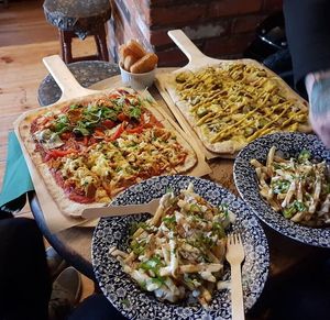 Two large size pizzas - left is half med veg and half buffalo "chicken", other is new york deli with vegan pastrami (plus fries) at The Plasterers Arms in Norwich