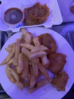 Curry sauce & pea bomb at top. Chips with 1 battered tofu, half a battered sausage and half a fish    at Capplemans Fish and Chips in Scarborough