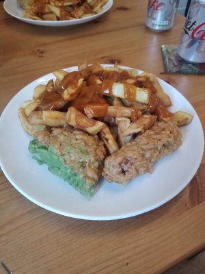 Chips, curry sauce, sausage and mushy pea bomb at Capplemans Fish and Chips in Scarborough