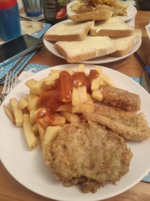 Shared portions of chips, tofu, sausage and mushy pea bombs at Capplemans Fish and Chips in Scarborough