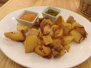Patatas bravas with mojo verde and romesco sauces at Raices in Pamplona