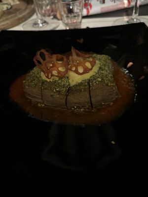 Sliced aubergine in pistachio crust on red pepper cream with saffron mousse and lotus root chips  at Ad Forum in Aosta