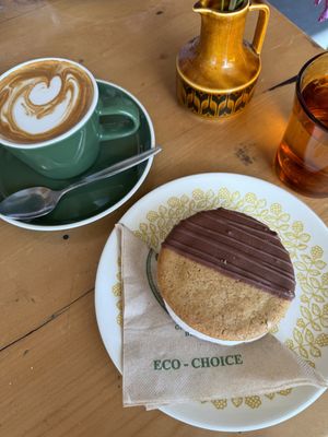 A soy flat white and a ‘half baked’ brand banoffee sammy   at Tom Thumb in Paraparaumu Beach