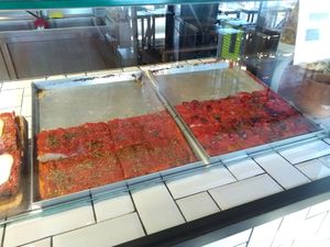 Focaccia they sell for 2 euros (the two are vegan: one plain with tomato sauce and the other one with peppers) at Amico Bio Mergellina in Naples