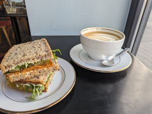 Vegan pepperoni and oat milk latte at STOR in Warsaw