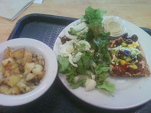 Raw pizza, salad and herb potatoes at Food and Thought in Naples