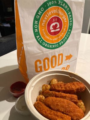 Trying out the new Beyond Chicken red hot chicken tenders, subbed tater tots for crinkle fries for $1 extra at Next Level Burger - Potrero Hill in San Francisco