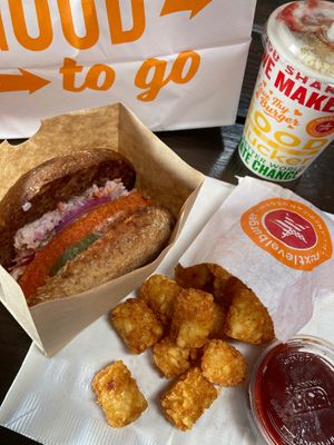 Red hot chick'n burger and tots with strawberry cheesecake shake at Next Level Burger - Potrero Hill in San Francisco