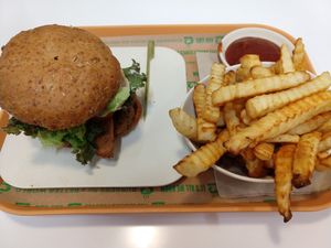 Sausage bacon burger and crinkle cut fries at Next Level Burger - Potrero Hill in San Francisco