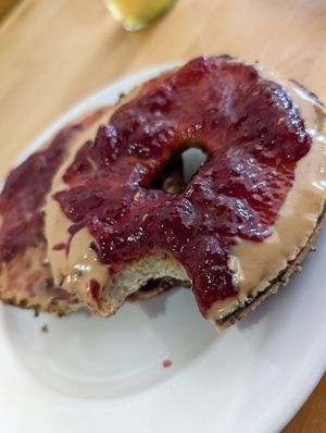 I got excited and took a bite. Toasted bagel with PB&J at Sweetpea Baking Company in Portland