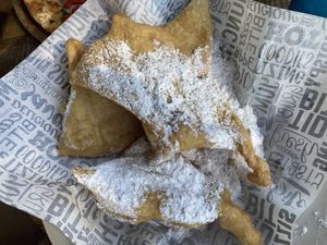 Vegan Beignets with plenty of powdered sugar to spare.  at G's Pizza - Howard Ave in New Orleans