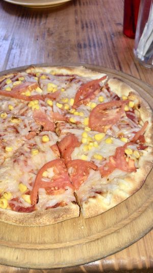 Pizza with vegan cheese, tomato and corn, was great:) at G's Pizza - Howard Ave in New Orleans