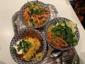 An assortment! Spicy chili son carné (left), vegetable tajine (right), and Tibetan mama (bottom) at Le Botaniste - Soho in New York City