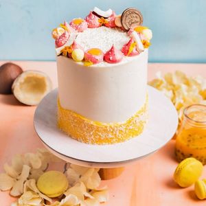  This Vanilla cake is filled with a fruity and tart pineapple compote and passionfruit caramel, frosted with a smooth buttercream and a layer of dessicated coconut.  at An Ode to Gaia in Mumbai