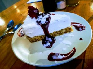 Coconut cheesecake, crispy bottom, soft, smooth, light and mouth melting coconut "cheese" and then raspberry (I think) sweet sauce. Masterpiece! at Give Cafe in Canggu