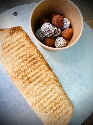 Black Beans Falafel Wrap toasted with a sandwich press to give it a crispy touch 🖤🧆🌯 
+ Homemade Energy Balls / Bombs 💣💣💣 at Garbanzo - Falafel & Hummus Bar in Vienna