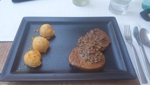 Dark vegan steak in green pepper sauce at Güjžina - Green One Bistro in Ljubljana