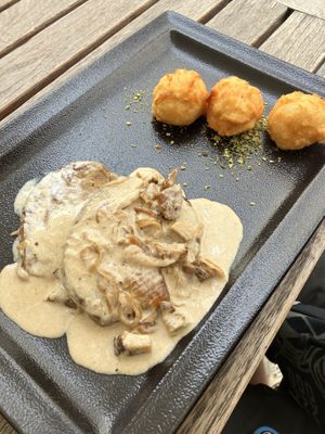 Seitan steak with vegan ham&cream sauce  at Güjžina - Green One Bistro in Ljubljana