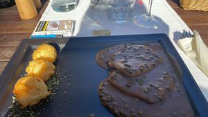 Dark vegan steak with a green pepper sauce  at Güjžina - Green One Bistro in Ljubljana