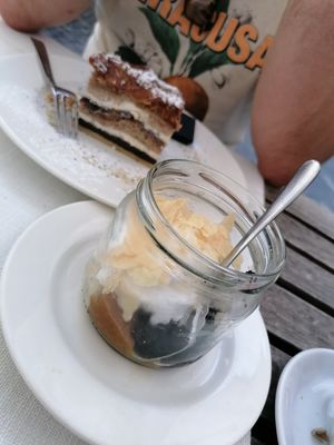 Dessert of the feast for 2: the vegan dessert was a decomposed version without the cream layer, topped with vegan whipped cream (the traditional non vegan version in the back) at Güjžina - Green One Bistro in Ljubljana