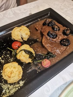 Dark vegan steak, flambeéd sauce & dry plums at Güjžina - Green One Bistro in Ljubljana