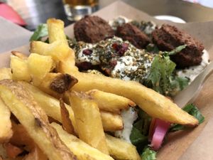 Falafel bowl with hummus, fries & some  at Paralela in Prague