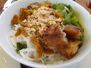 Dry noodle with lemongrass and tumeric with spring roll at Au Lac Healthy World - Pham Ngu Lao in Ho Chi Minh City