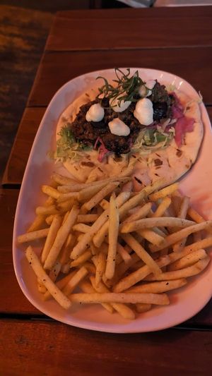XO eggplant gyros w/pickled cabbage, shredded lettuce, mixed herbs, grilled naan + fries $18.50 at Yulli's Brews in Alexandria