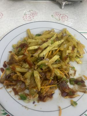 Loaded fries with veggies cheese and some spices   at Milan's Restaurant in Moshi