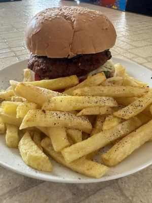 Freshly prepared veggie burger with chips  at Milan's Restaurant in Moshi