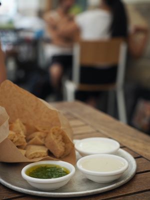 Bread and sauces for free: tahini and cilantro (sour cream is not vegan) at Miznon in Vienna